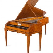 An Austrian Enamel Inset Burlwood Harpsichord
Likely