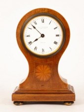 A balloon-shaped mahogany mantel clock,