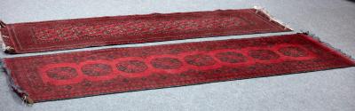Two modern Afghan rugs on a red 36daa1