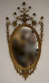 NEOCLASSICAL STYLE OVAL GILTWOOD MIRRORTopped