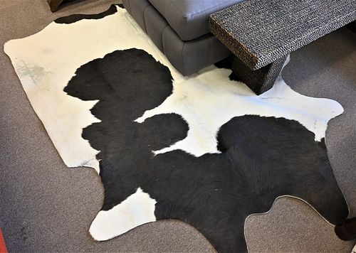 THREE COWHIDE RUGS EACH APPROXIMATELY 377a13