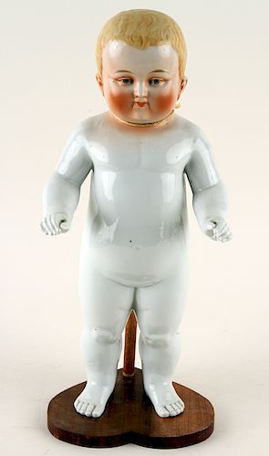 PORCELAIN FIGURE OF A BABY ON WOOD 38b390
