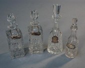 FOUR CUT CRYSTAL DECANTERS WITH SILVER