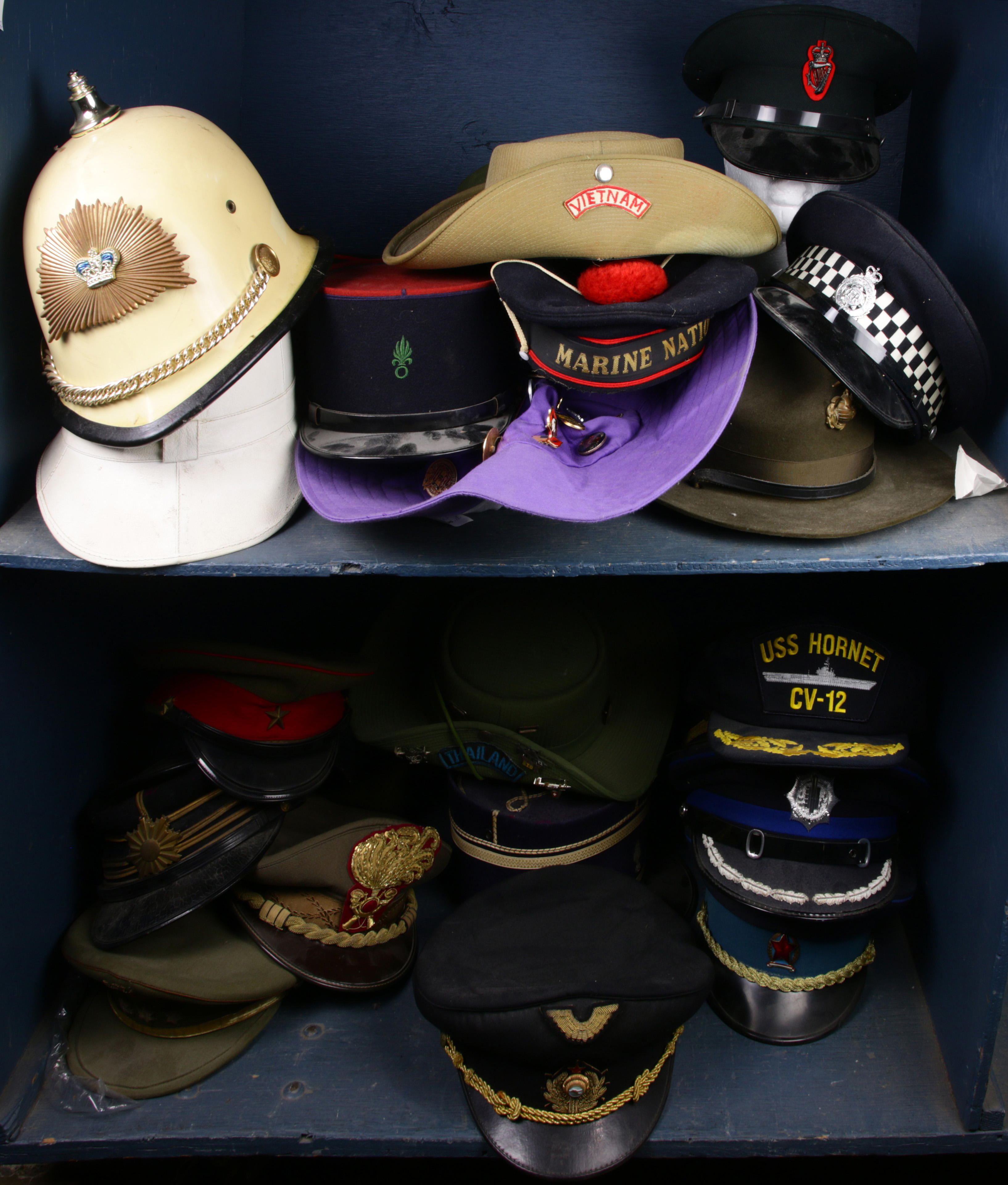 TWO SHELVES OF MILITARY HATS Two 3a6b6d