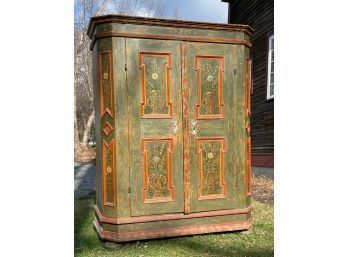 A large antique painted cupboard