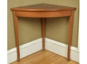 An artisan crafted mahogany corner table