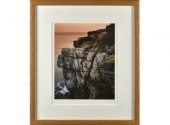 Framed photograph, cliffs by ocean,