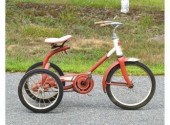 Antique tricycle in red and white paint