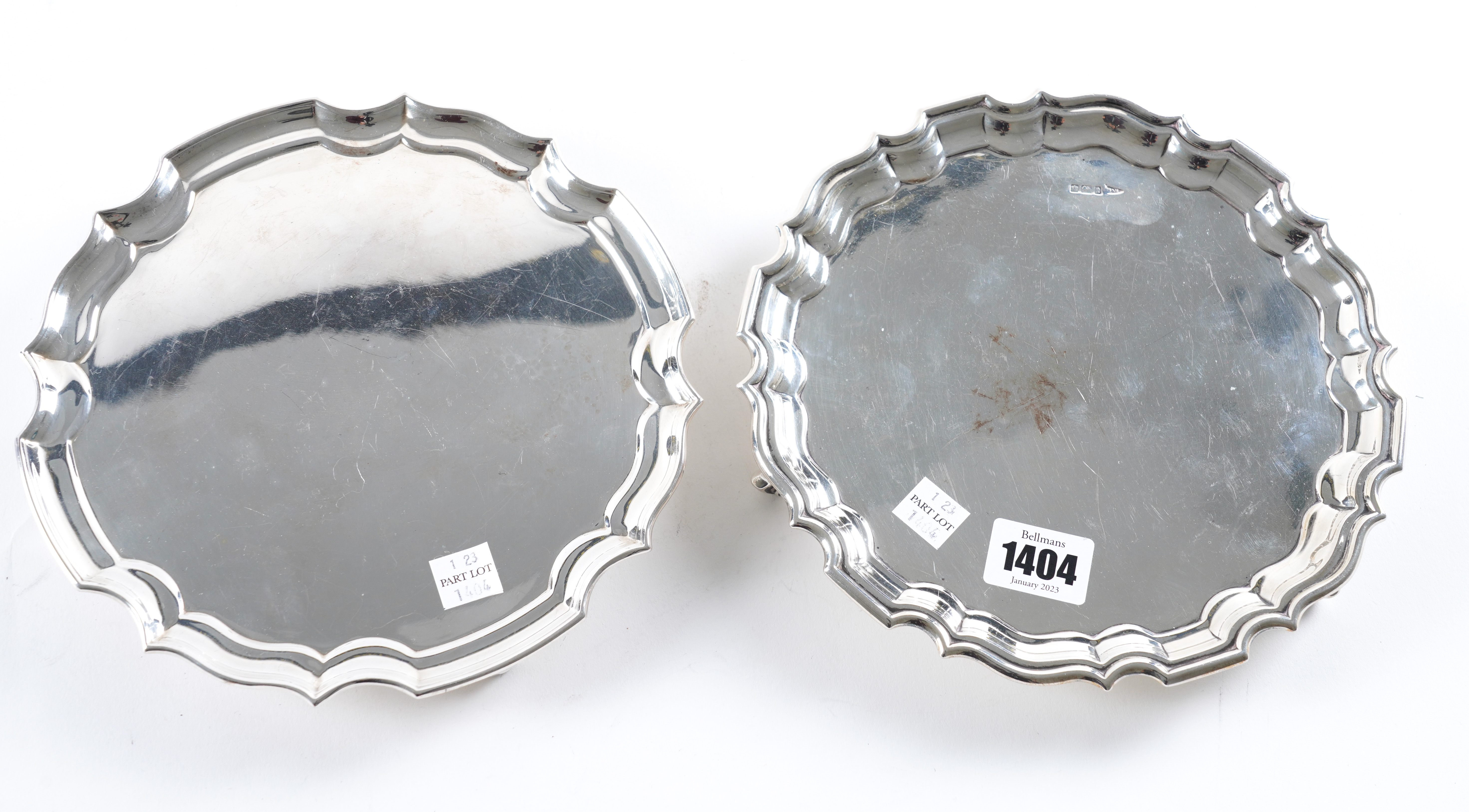 A SILVER WAITER AND TWO PLATED