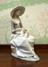 A Lladro figurine of a woman seated