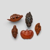 FOUR SEED CARVINGS AND ONE SMALL CARNELIAN