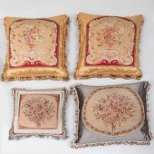 FOUR FLORAL NEEDLEWORK PILLOWS WITH
