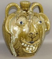 TWO HANDLED FOLK ART FACE JUG BY CHARLES