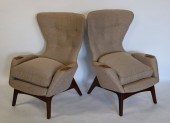 A PAIR OF UPHOLSTERED WING BACK CHAIRS