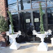 A PAIR OF WHITE PAINTED CAST IRON URNS