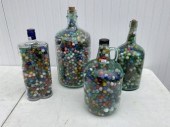 Four glass bottles filled with vintage