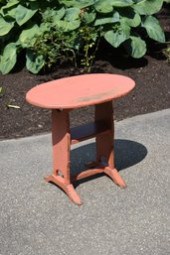 A vintage oval table/stand in salmon