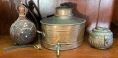 An antique copper samovar/covered vessel