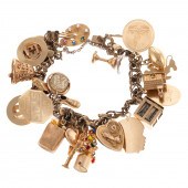 A CHARM BRACELET WITH 25 GOLD CHARMS