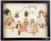 FRAMED GROUP OF SMALL DOLLS AND ACCESSORIESFramed