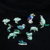 A GROUP OF TEN HEREND ANIMALS IN A GREEN