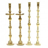 TWO PAIRS OF FOUR-FOOT TALL BRASS CANDLESTICKS