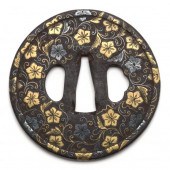 A JAPANESE IRON TSUBA WITH GOLD AND