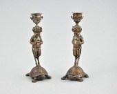 A Pair of Bronze Candlesticks by