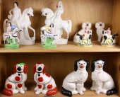 TWO SHELVES OF STAFFORDSHIRE DOGS